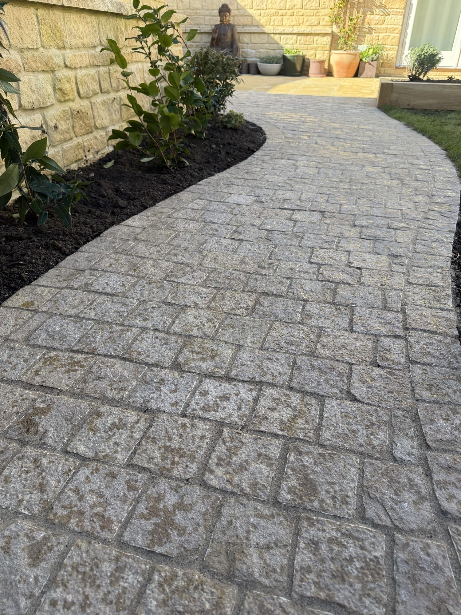 Close, low-angle view of a cobble-effect imprinted concrete path