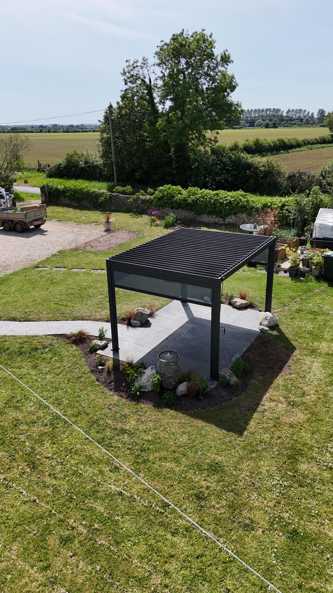 Aluminium louvred pergola with open countryside behind